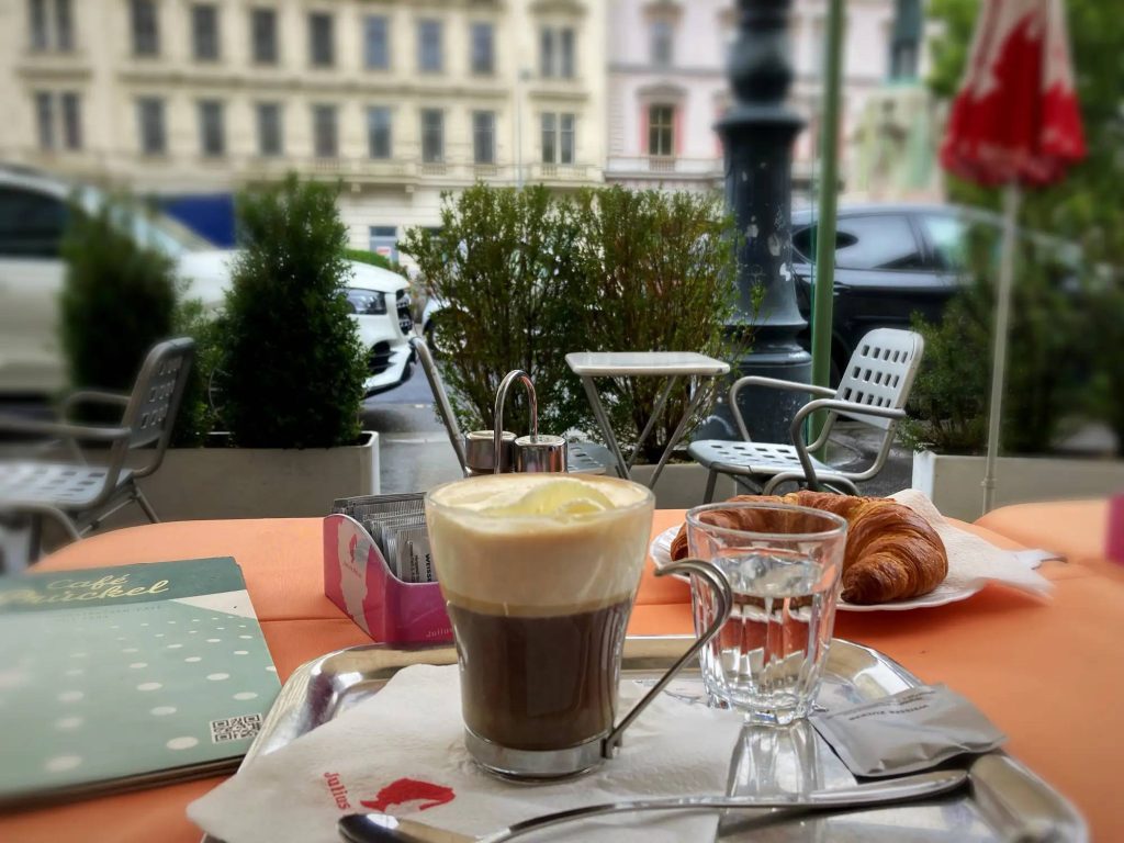 Coffee and croissant on the terrace of Café Prückel at Dr.-Karl-Lueger-Platz near Stubenring in Vienna.