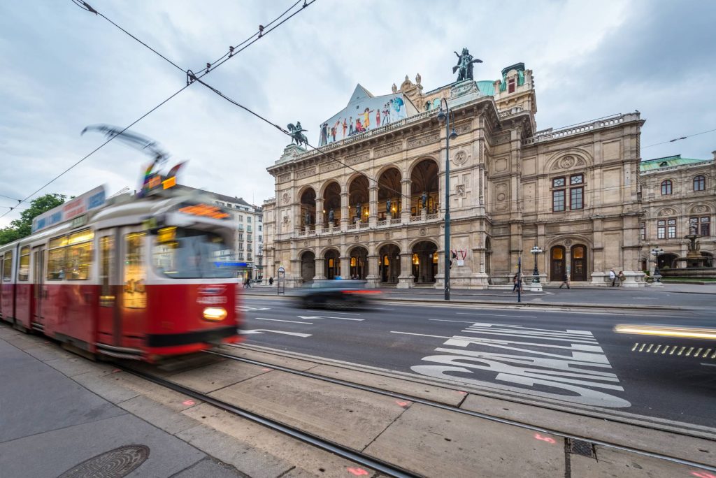 Blurred tram by the Vienna State Opera in Vienna Austria ©Anibal Trejo Adobe Stock Vienna symbolic travel: where architecture, rhythm, and memory begin to overlap.