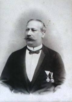 Black-and-white portrait of Josef Inwald Edler von Waldtreu wearing a dark formal suit, bow tie and two decorations pinned to his chest.